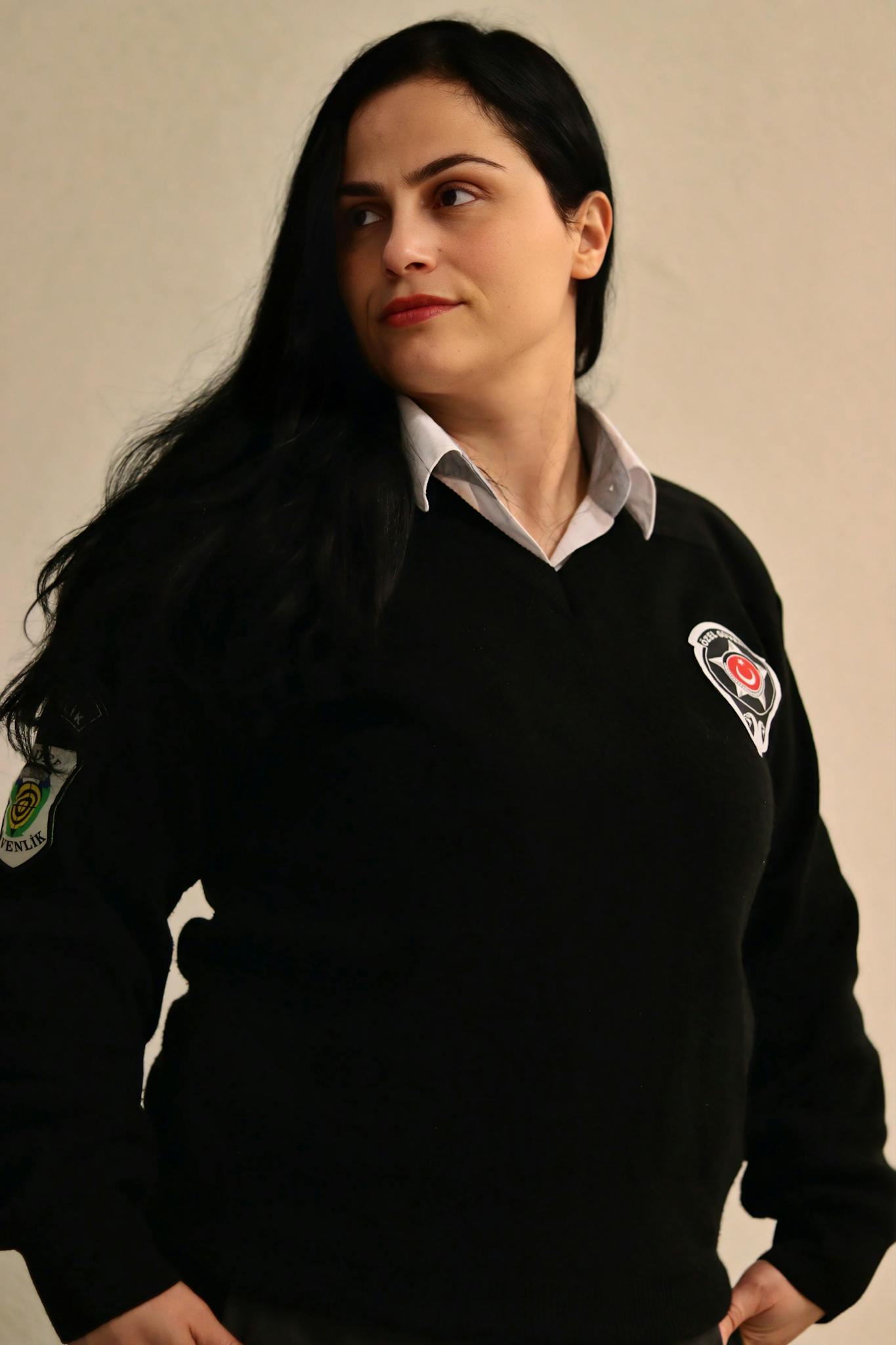 Portrait of a female security officer in a uniform, exhibiting confidence and professionalism.
